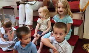 Group of young children listening to the children's message