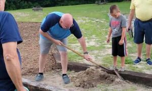 Pastor Eddie Thomas working on a digging project outside