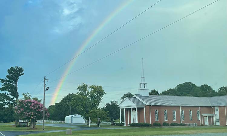 Rainbow in sky over Juniper Springs Baptist Church